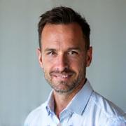 Professional headshot of Coach Marcus Thorne, a confident, fit man.