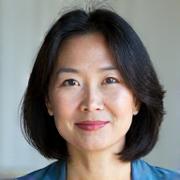 Professional headshot of Coach Sara Chen, a calm, mindful woman.